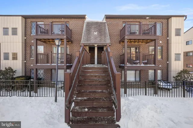 a view of a brick house with many windows and a wooden floor