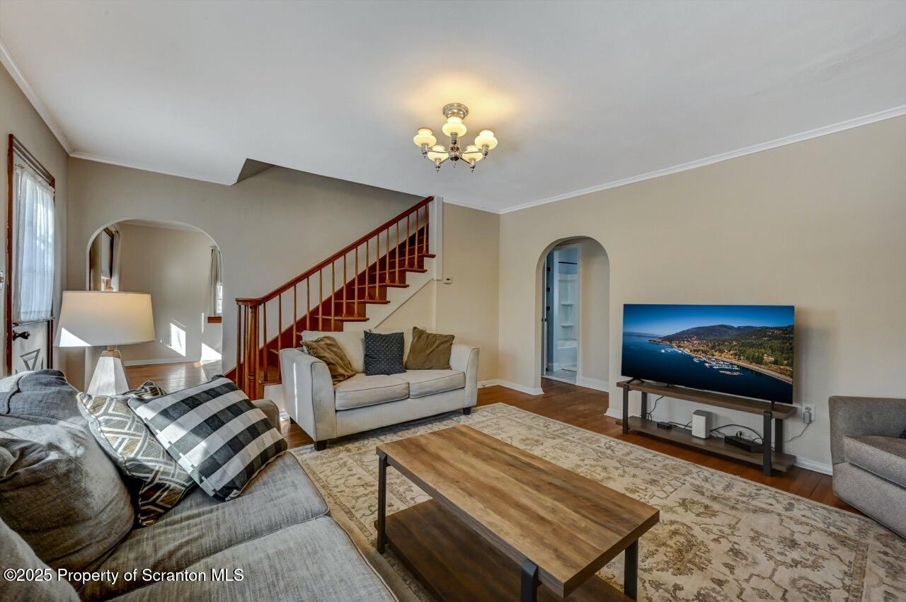 117 Griffin Pond Road Clarks Summit, PA 18411 - Photo 11 of 65 a living room with furniture a chandelier and a flat screen tv