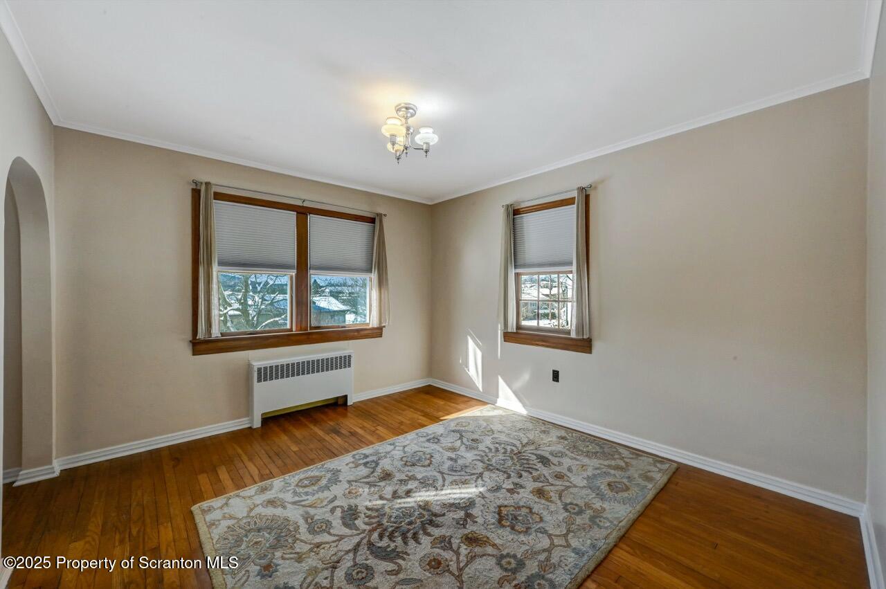 117 Griffin Pond Road Clarks Summit, PA 18411 - Photo 13 of 65 a view of an empty room with window and wooden floor