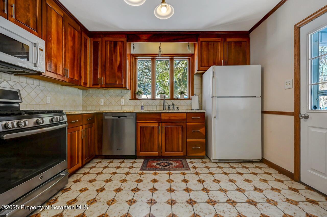 117 Griffin Pond Road Clarks Summit, PA 18411 - Photo 17 of 65 a kitchen with a stove a sink and a refrigerator