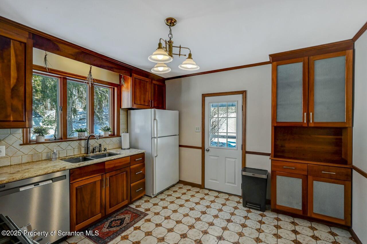 117 Griffin Pond Road Clarks Summit, PA 18411 - Photo 19 of 65 a kitchen with stainless steel appliances granite countertop a refrigerator and a sink