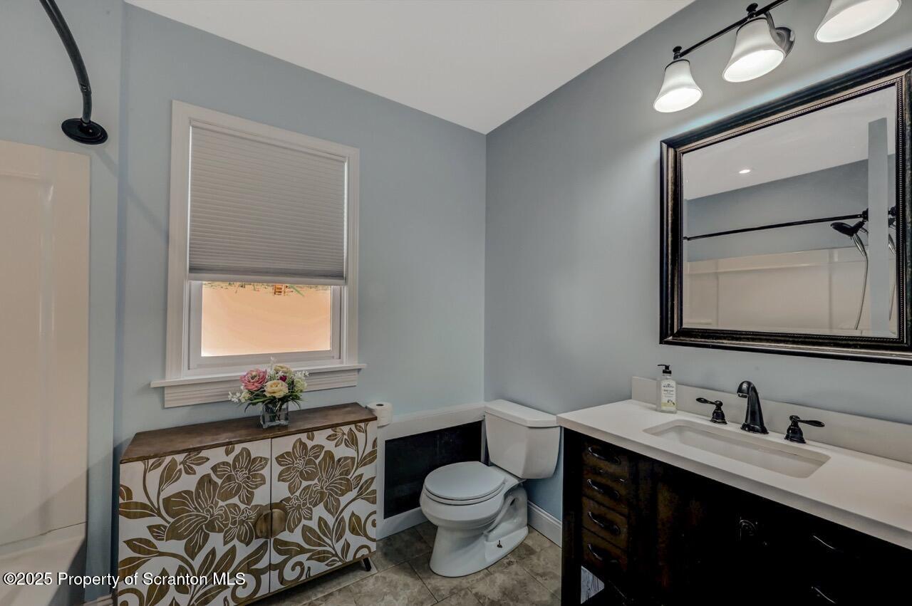 117 Griffin Pond Road Clarks Summit, PA 18411 - Photo 25 of 65 a bathroom with a toilet sink vanity granite and mirror