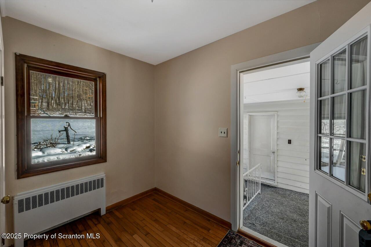117 Griffin Pond Road Clarks Summit, PA 18411 - Photo 29 of 65 a view of an empty room with wooden floor and a window