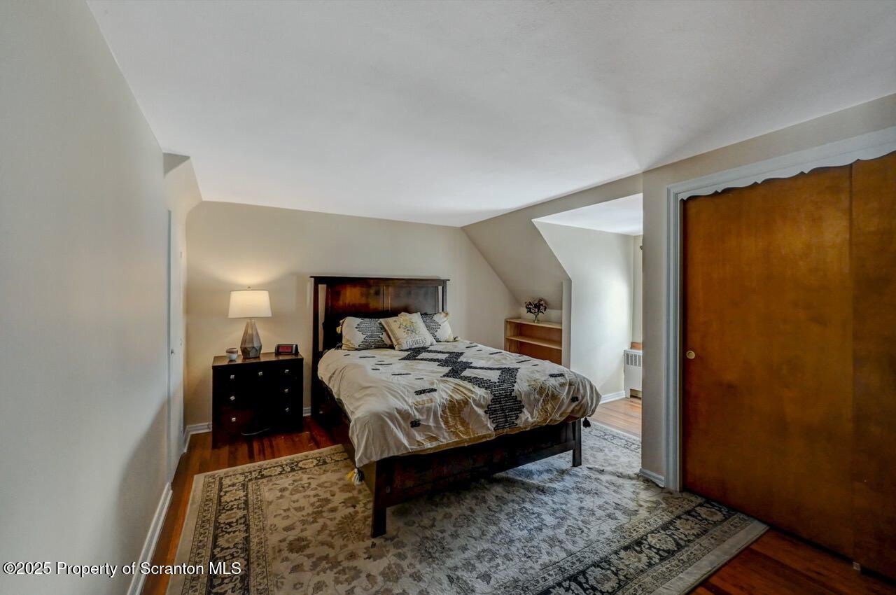 117 Griffin Pond Road Clarks Summit, PA 18411 - Photo 36 of 65 a bedroom with a bed and wooden floor