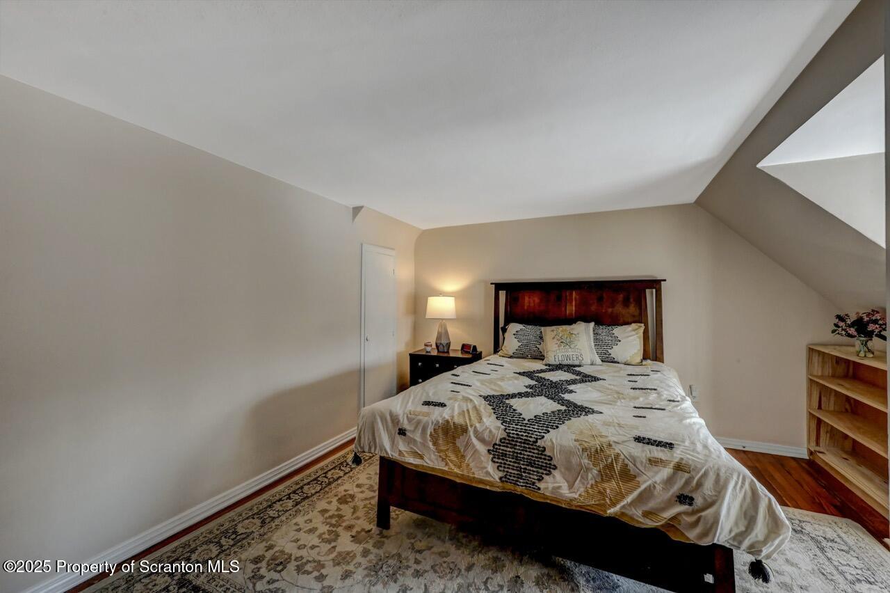 117 Griffin Pond Road Clarks Summit, PA 18411 - Photo 39 of 65 a bed sitting in a bedroom next to a lamp