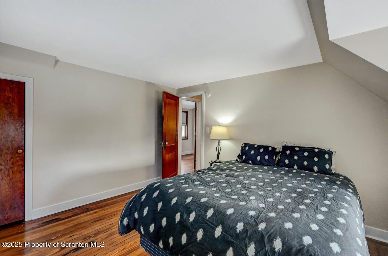 117 Griffin Pond Road Clarks Summit, PA 18411 - Photo 43 of 65 a bedroom with a bed and wooden floor