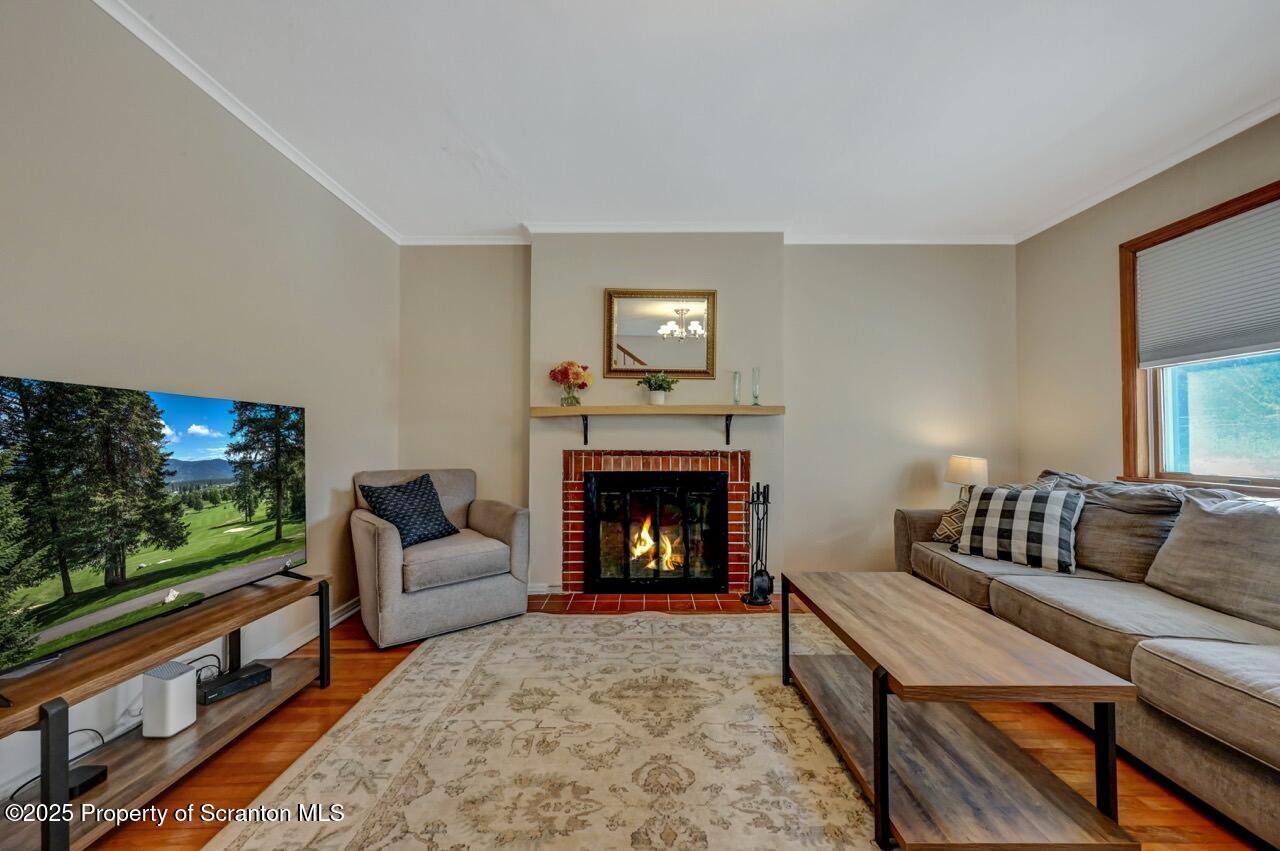117 Griffin Pond Road Clarks Summit, PA 18411 - Photo 9 of 65 a living room with furniture a flat screen tv and a fireplace