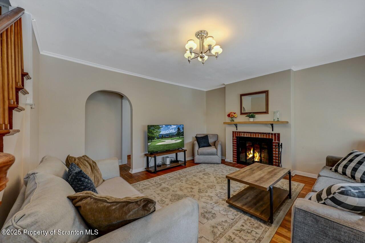 117 Griffin Pond Road Clarks Summit, PA 18411 - Photo 10 of 65 a living room with furniture a fireplace and a flat screen tv