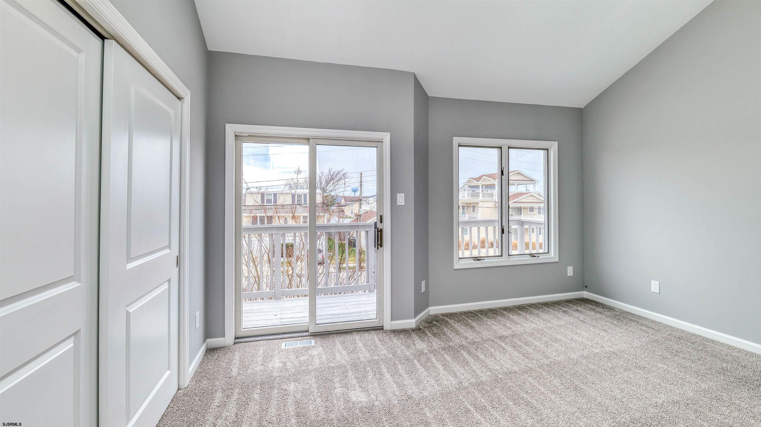 101 11th Street North, Unit A Brigantine, NJ 08203 - Photo 35 of 42 a view of an empty room with glass door and balcony