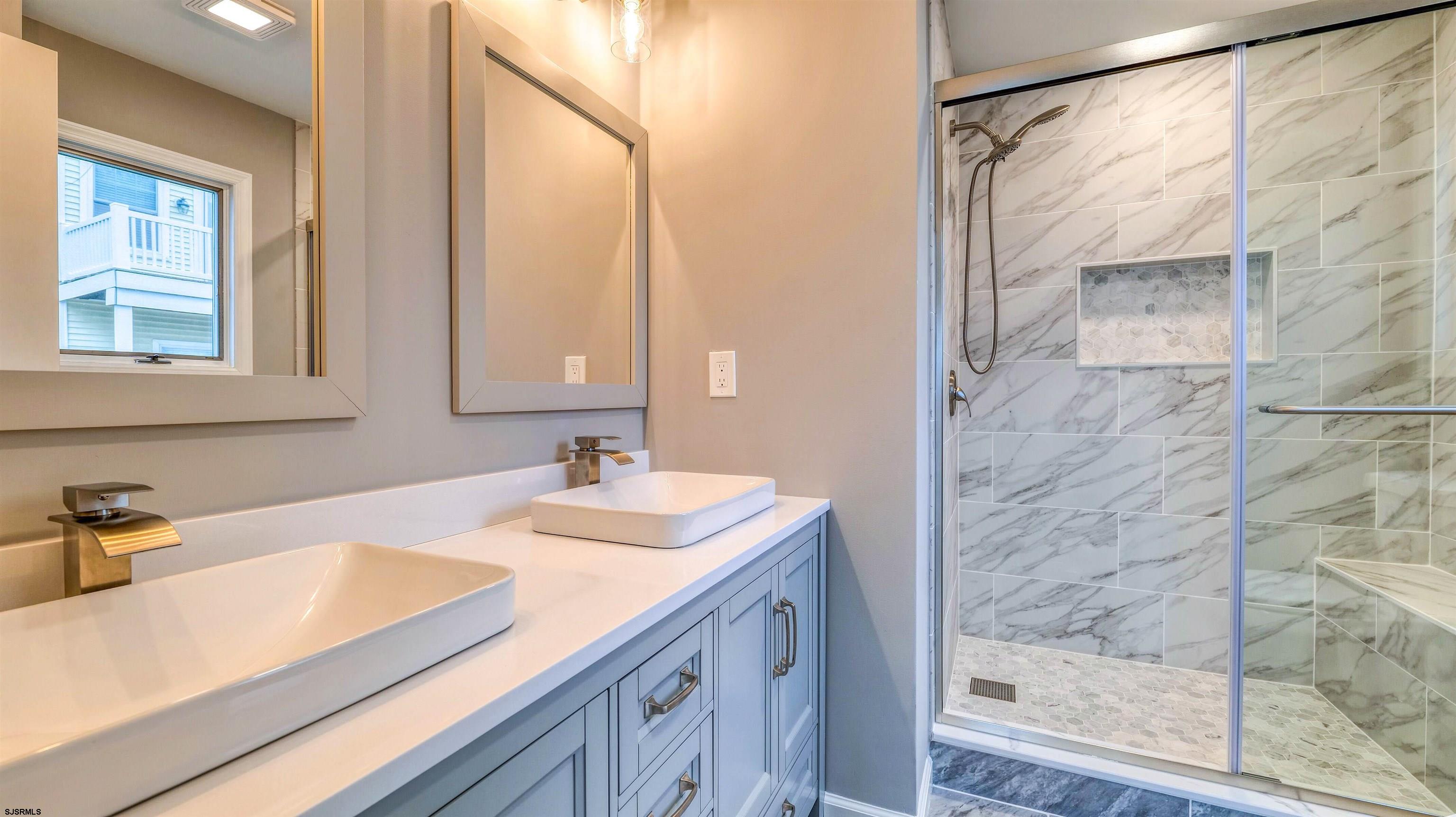 101 11th Street North, Unit A Brigantine, NJ 08203 - Photo 6 of 42 a bathroom with a sink and a mirror
