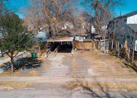 a view of a park with trees in the background
