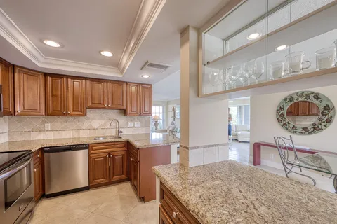 a kitchen with stainless steel appliances granite countertop a sink stove and cabinets
