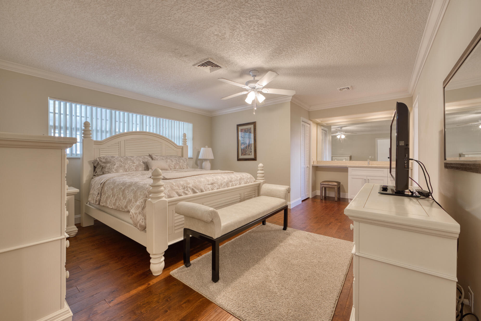 328 Cedar Key Circle Atlantis, FL 33462 - Photo 18 of 28 a bedroom with a bed a mirror and furniture