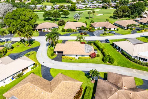 an aerial view of a house with a swimming pool yard and outdoor seating