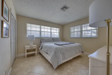 a bedroom with a bed chair and a window