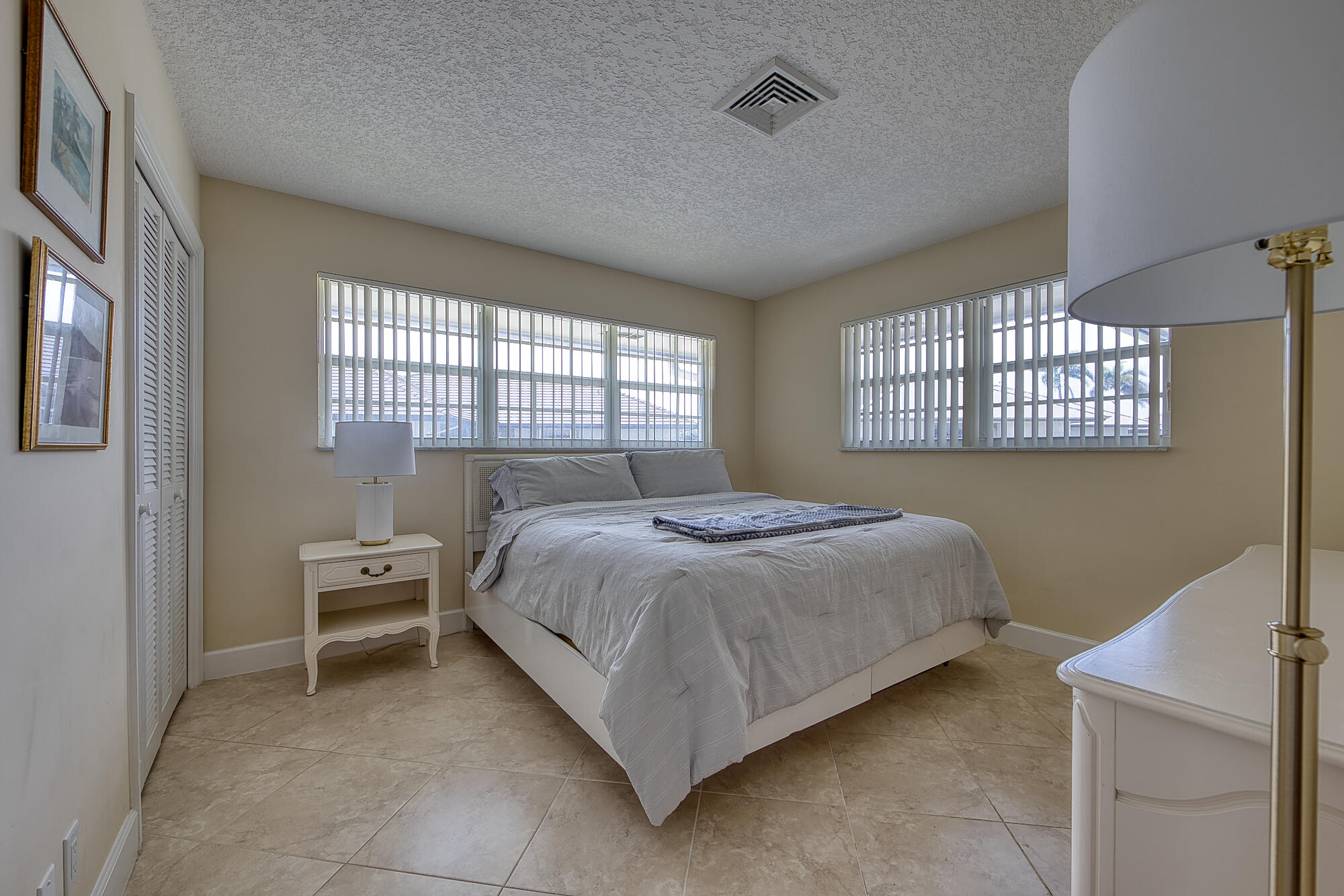 328 Cedar Key Circle Atlantis, FL 33462 - Photo 22 of 28 a bedroom with a bed chair and a window