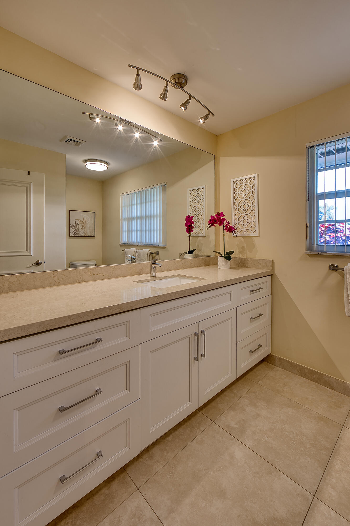 328 Cedar Key Circle Atlantis, FL 33462 - Photo 23 of 28 a view of a double vanity sink mirror and window