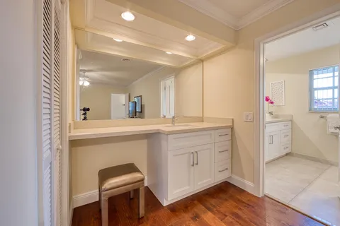 a bathroom with a sink vanity and a mirror