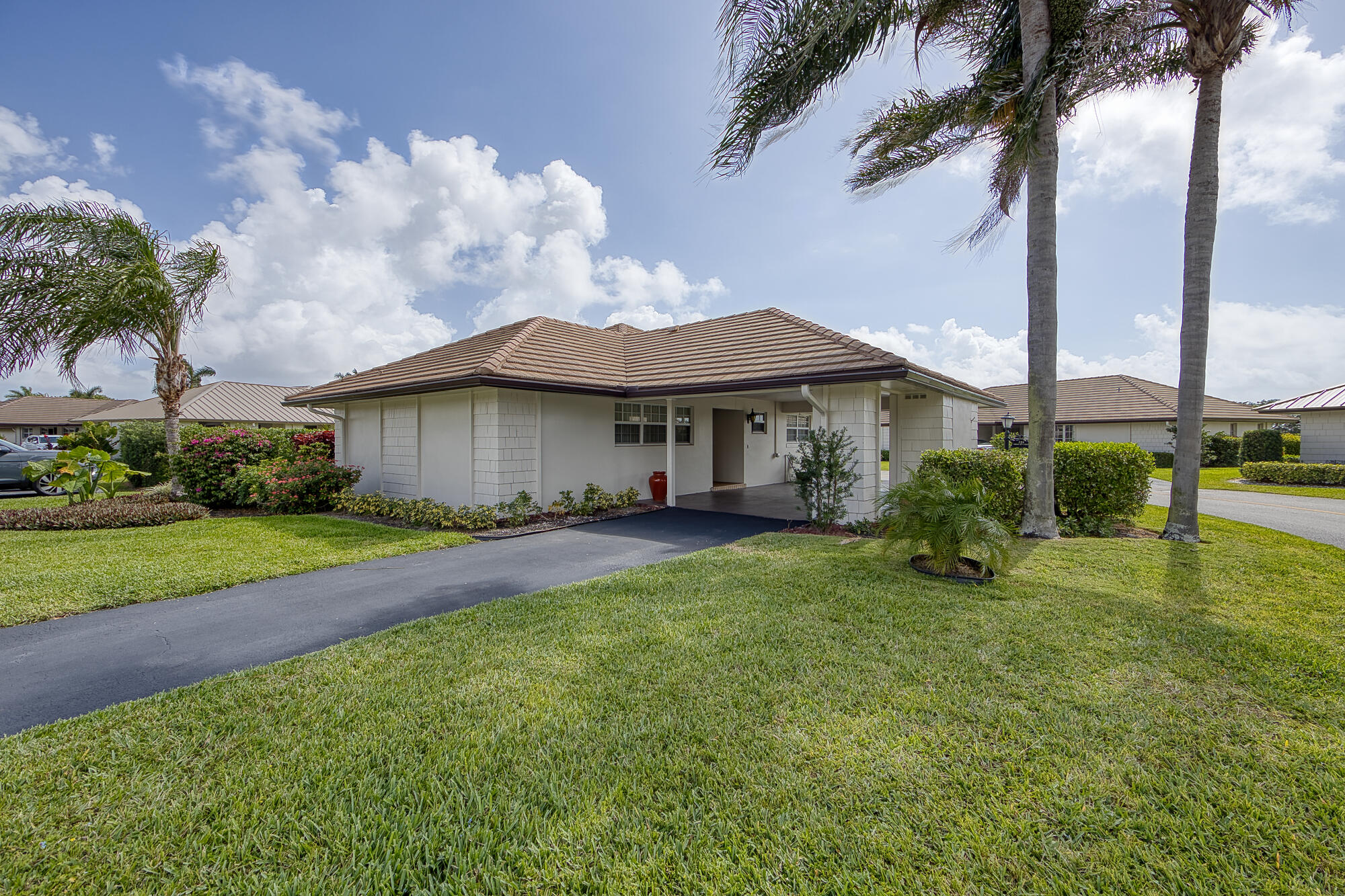 328 Cedar Key Circle Atlantis, FL 33462 - Photo 4 of 28 a view of a house with a big yard plants and large trees