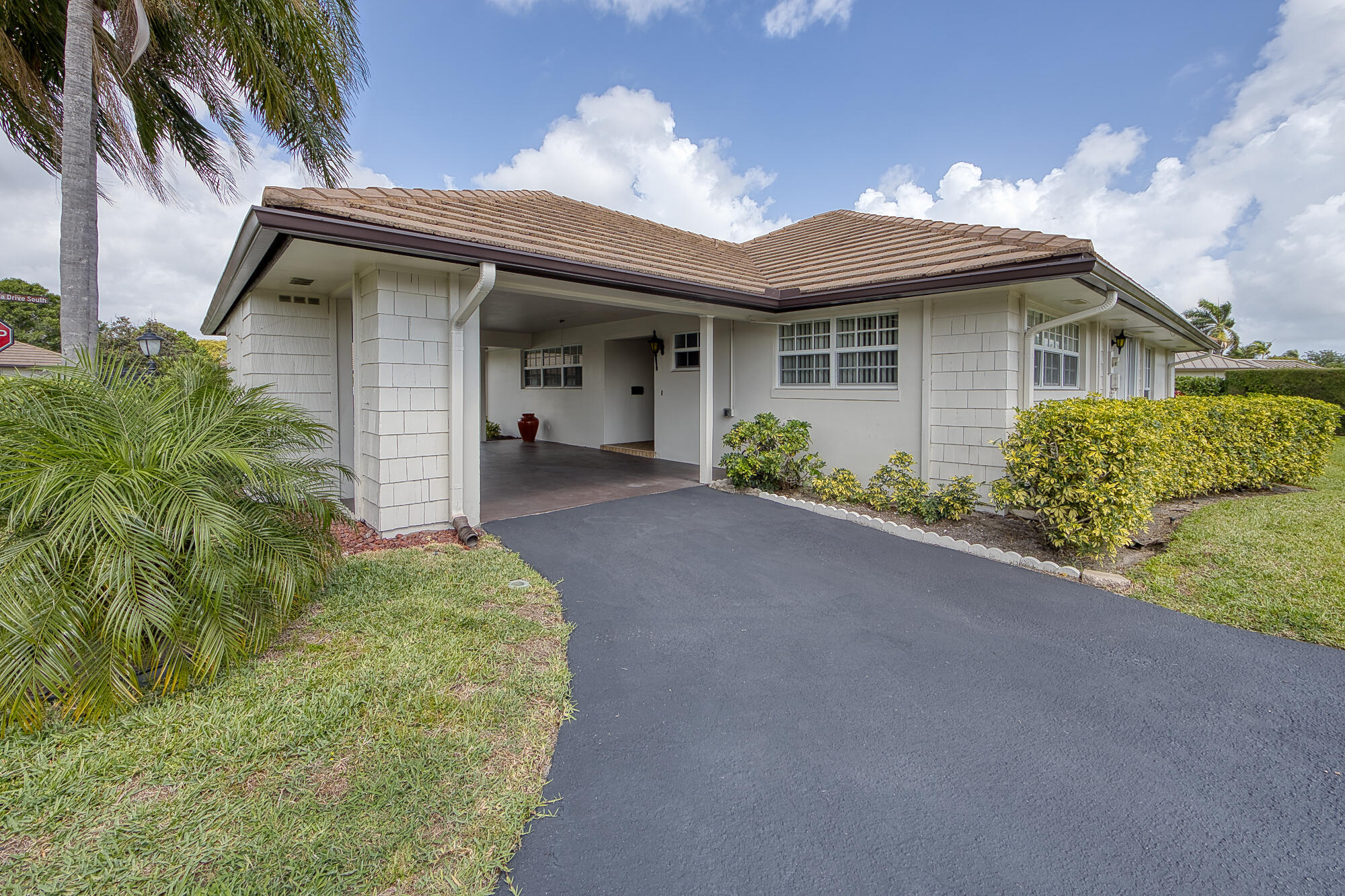 328 Cedar Key Circle Atlantis, FL 33462 - Photo 5 of 28 a front view of a house with garden