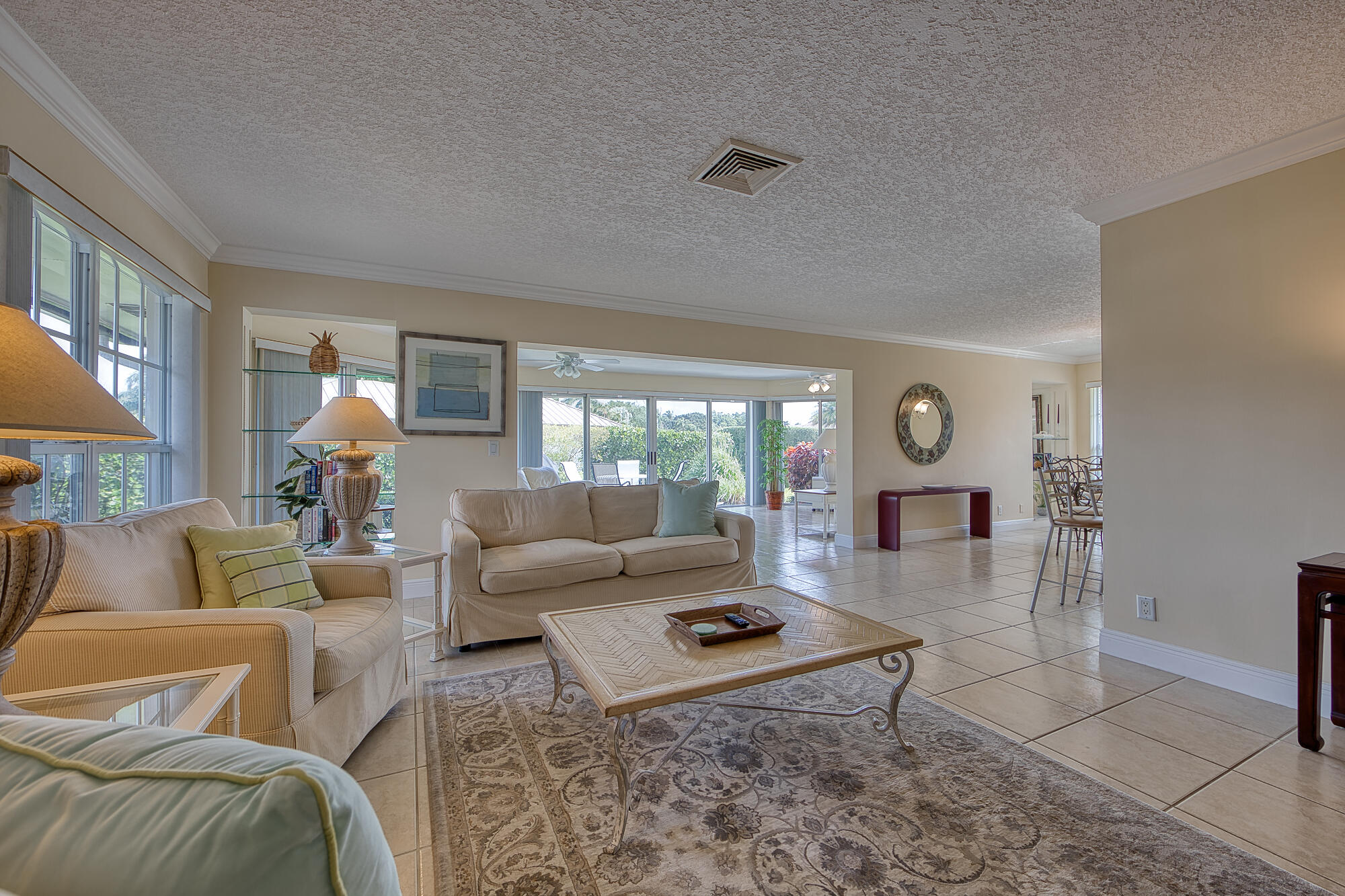 328 Cedar Key Circle Atlantis, FL 33462 - Photo 9 of 28 a living room with furniture and a large window