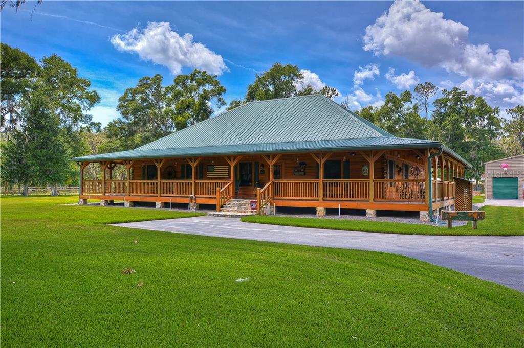 a view of a house with a yard porch and sitting area