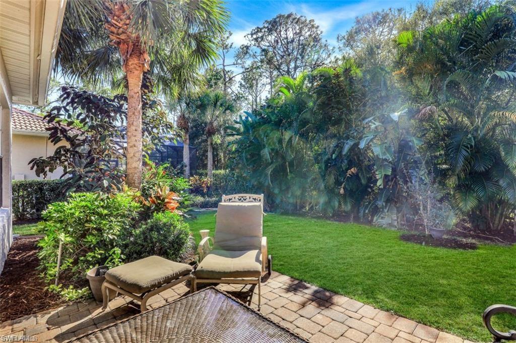 16156 Parque Lane Naples, FL 34110 - Photo 12 of 21 a view of backyard with seating space and trees