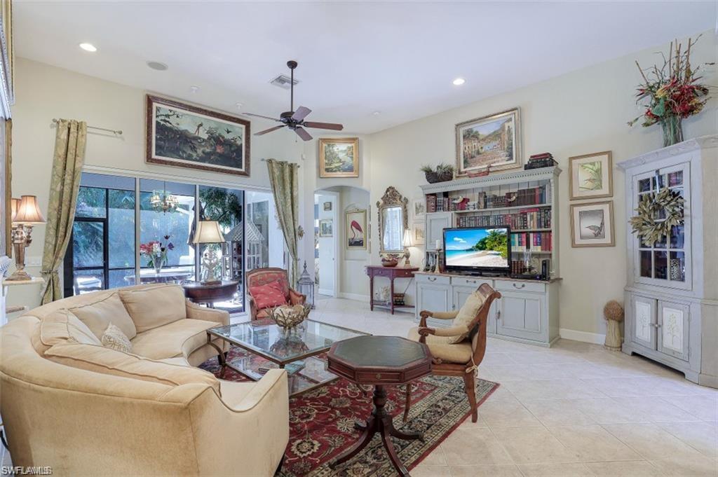 16156 Parque Lane Naples, FL 34110 - Photo 16 of 21 a living room with furniture a flat screen tv and a dining table
