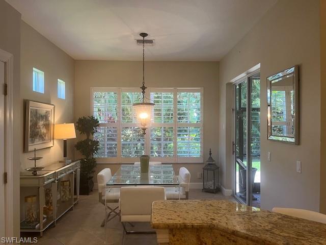 16156 Parque Lane Naples, FL 34110 - Photo 20 of 21 a living room with fireplace furniture and a chandelier