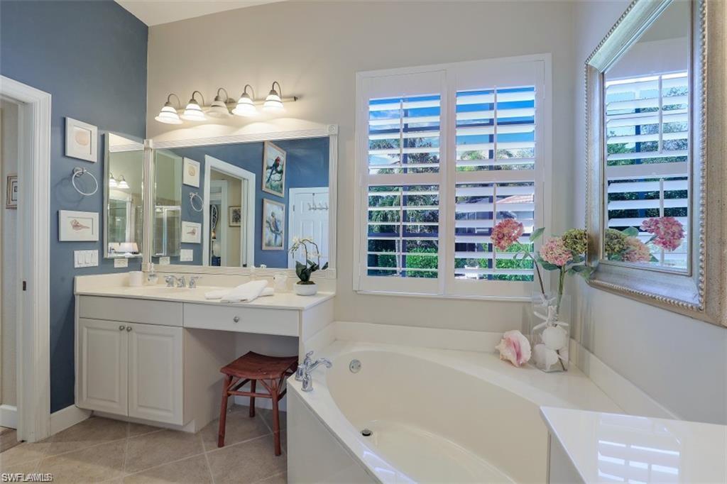 16156 Parque Lane Naples, FL 34110 - Photo 3 of 21 a bathroom with a tub sink and mirror