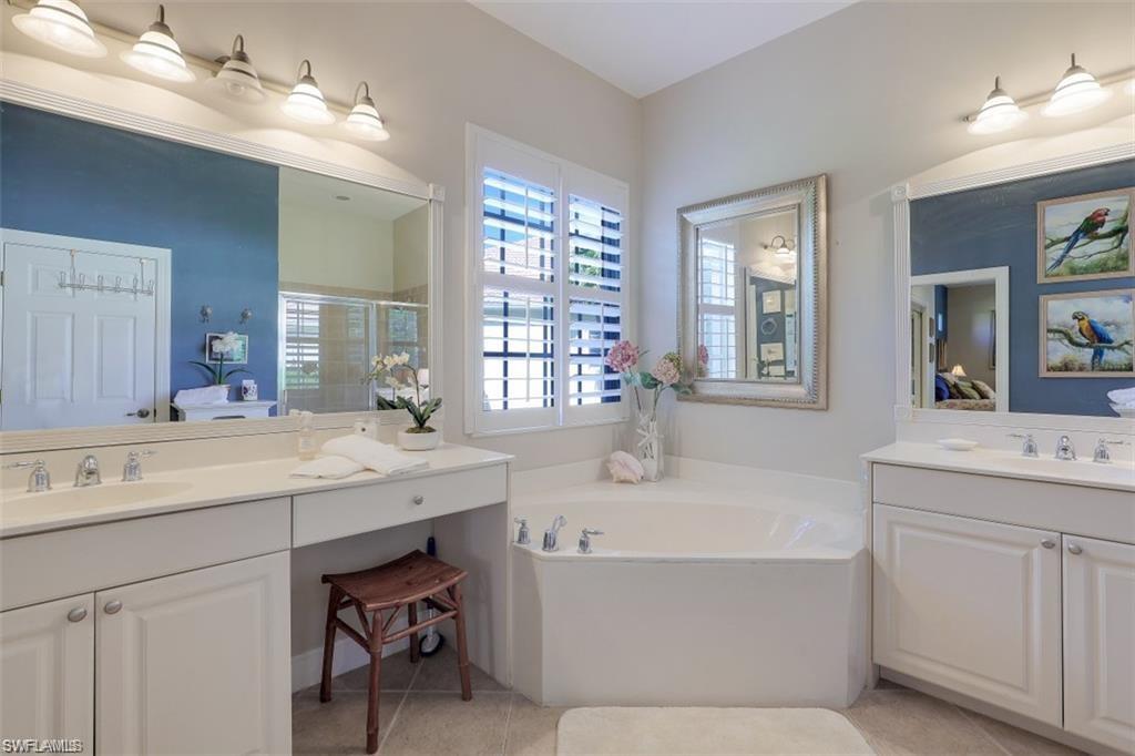 16156 Parque Lane Naples, FL 34110 - Photo 4 of 21 a bathroom with a tub double vanity sink and mirror