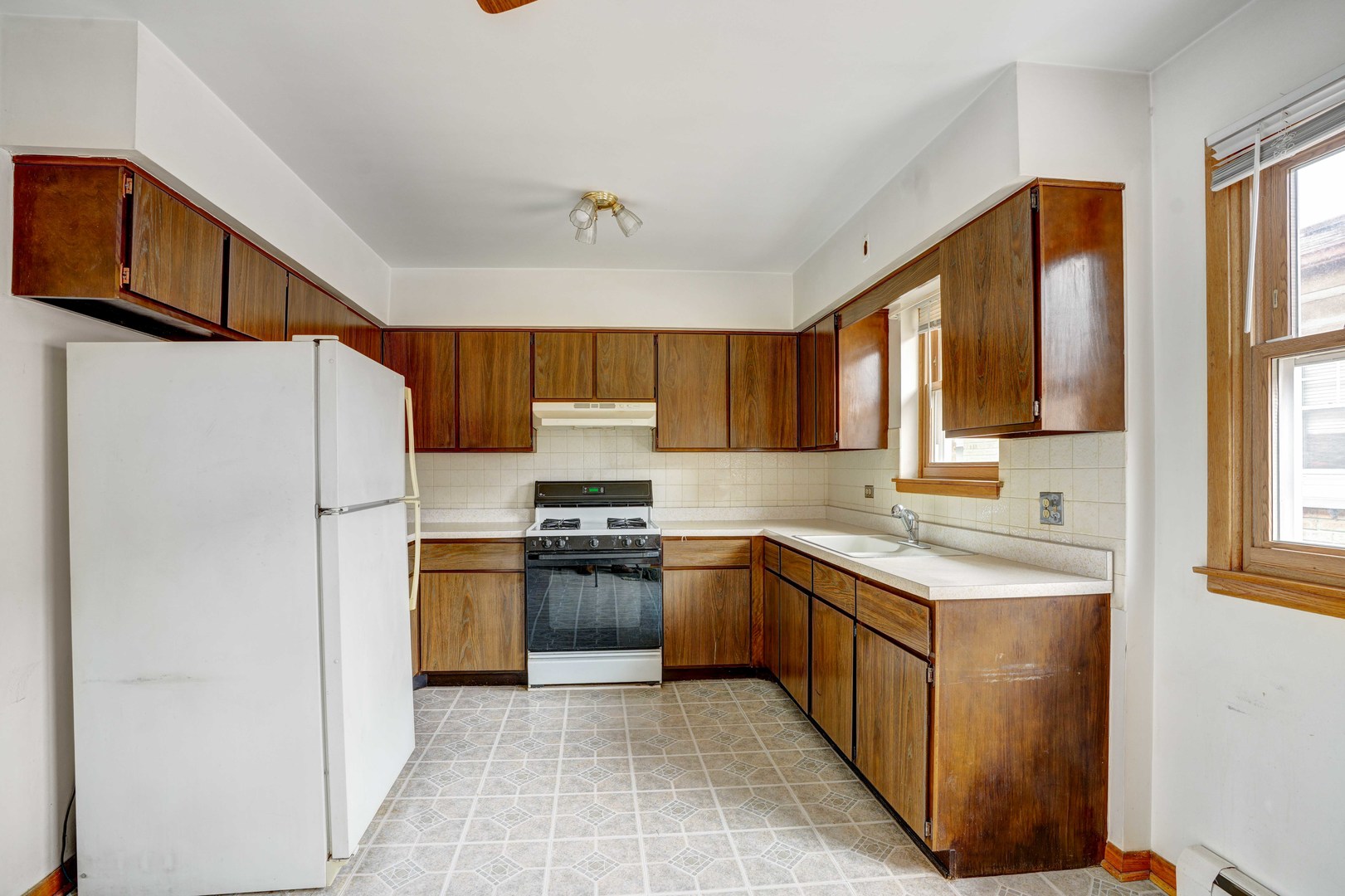 8444 West Gregory Street, Unit 3B Chicago, IL 60656 - Photo 2 of 9 a kitchen with stainless steel appliances granite countertop a refrigerator stove a sink dishwasher and wooden cabinets
