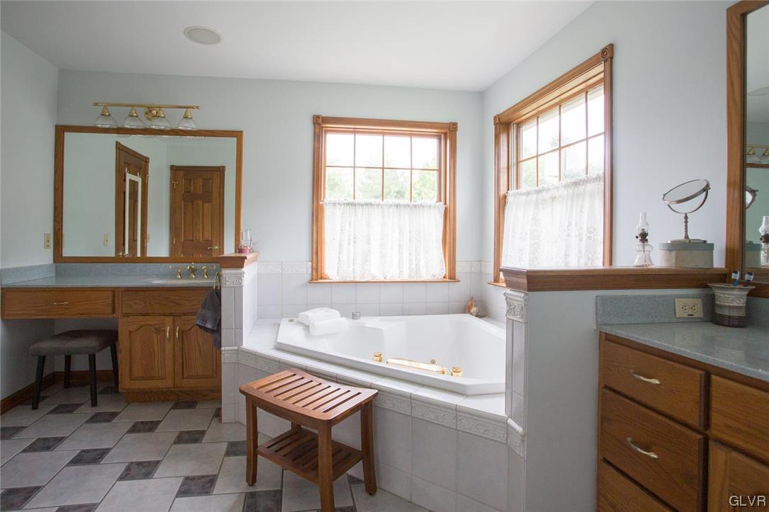 453 Colver Road Nazareth, PA 18064 - Photo 18 of 22 a bathroom with a sink a bathtub and a window