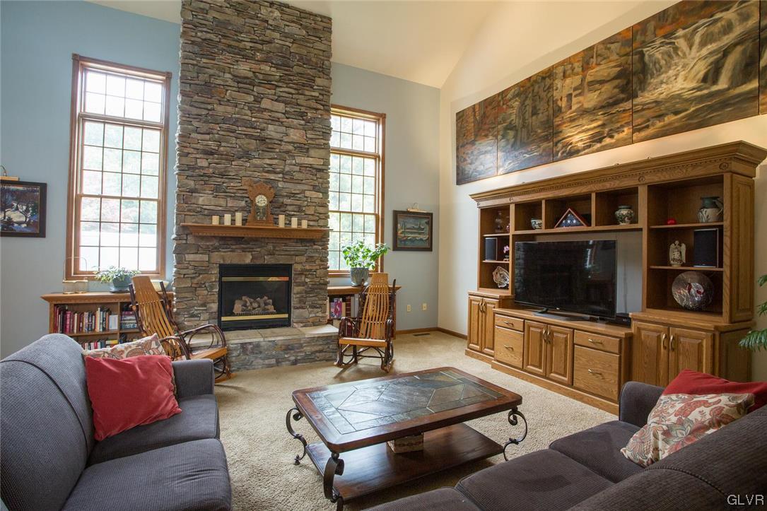 453 Colver Road Nazareth, PA 18064 - Photo 4 of 22 a living room with furniture a flat screen tv and a fireplace