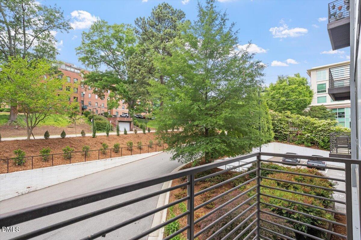 1300 St Marys Street, Unit 207 Raleigh, NC 27605 - Photo 15 of 31 a view of a balcony with a tree