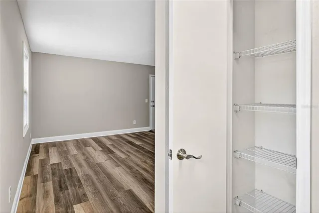 a view of a room with wooden floor and closet