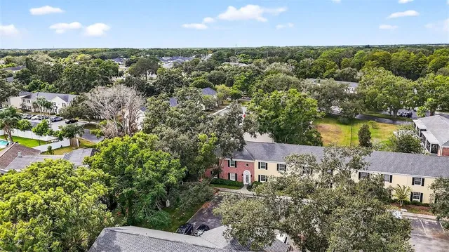 an aerial view of a house with a yard and lake view
