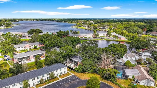an aerial view of a city with lots of residential buildings ocean and mountain view in back