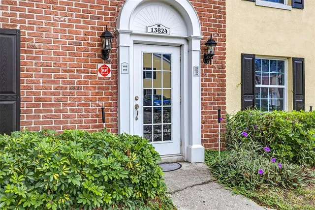a view of a house with potted plants