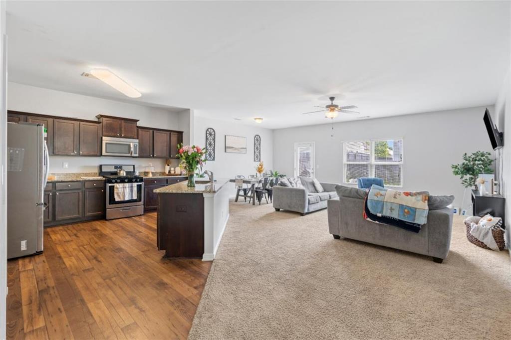 a living room with furniture and a kitchen