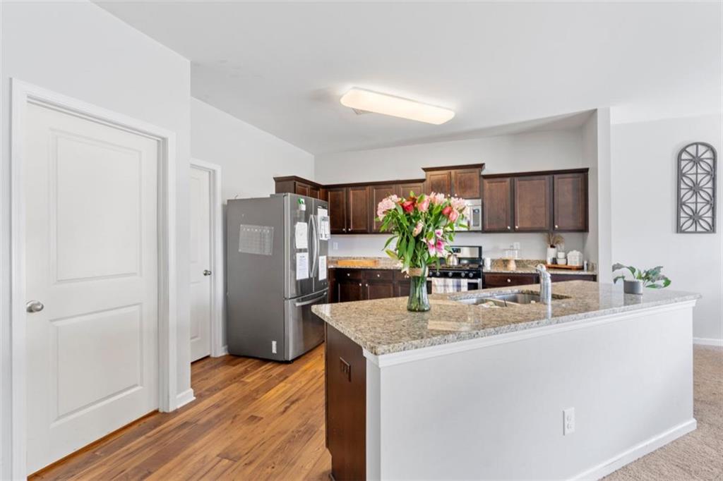 4219 Box Elder Path Gainesville, GA 30504 - Photo 13 of 35 a kitchen with sink refrigerator and microwave