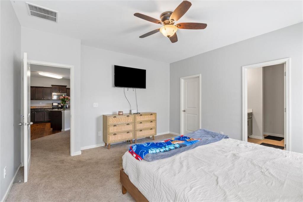4219 Box Elder Path Gainesville, GA 30504 - Photo 18 of 35 a bedroom with a bed and a flat screen tv