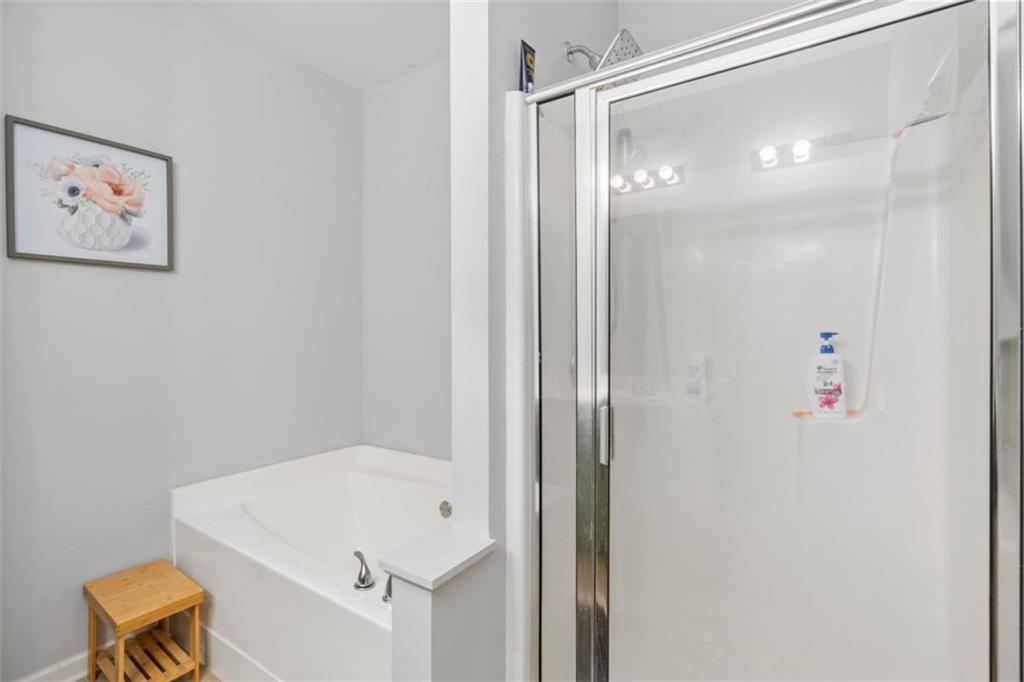 4219 Box Elder Path Gainesville, GA 30504 - Photo 20 of 35 a bathroom with a tub and shower