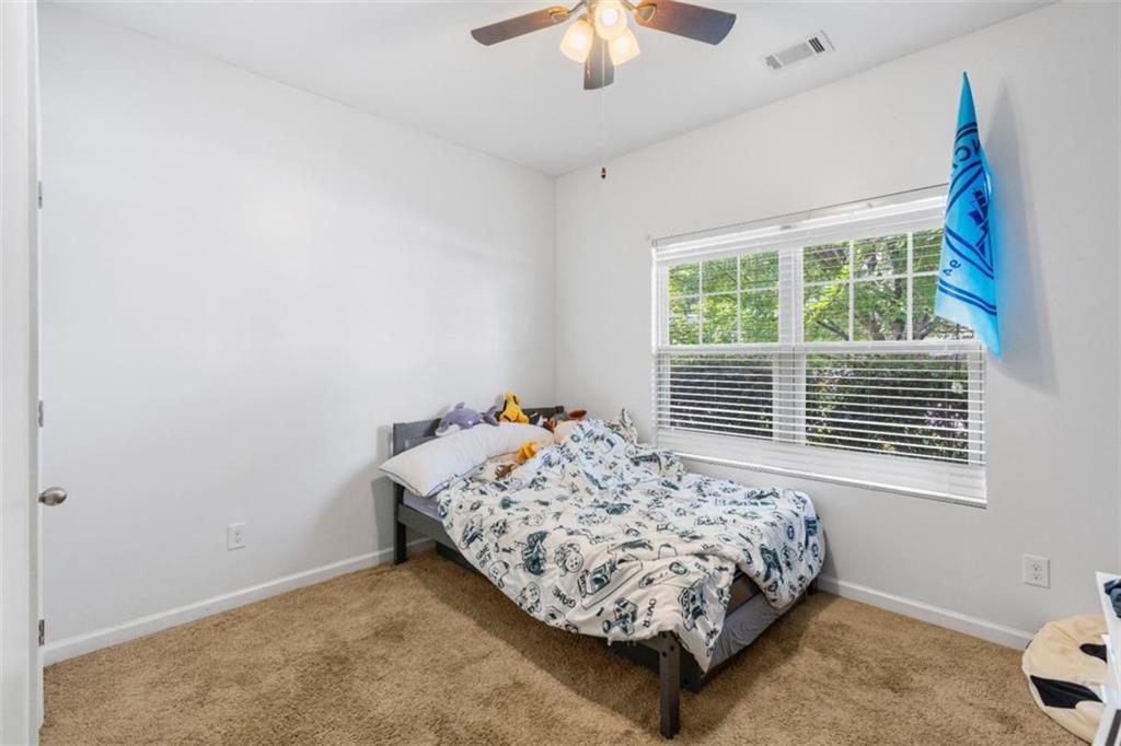 4219 Box Elder Path Gainesville, GA 30504 - Photo 23 of 35 a bed sitting in a bedroom next to a window