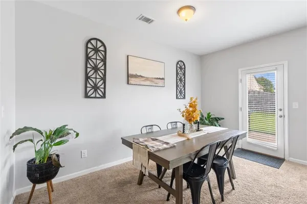 a view of a dining room with furniture and window