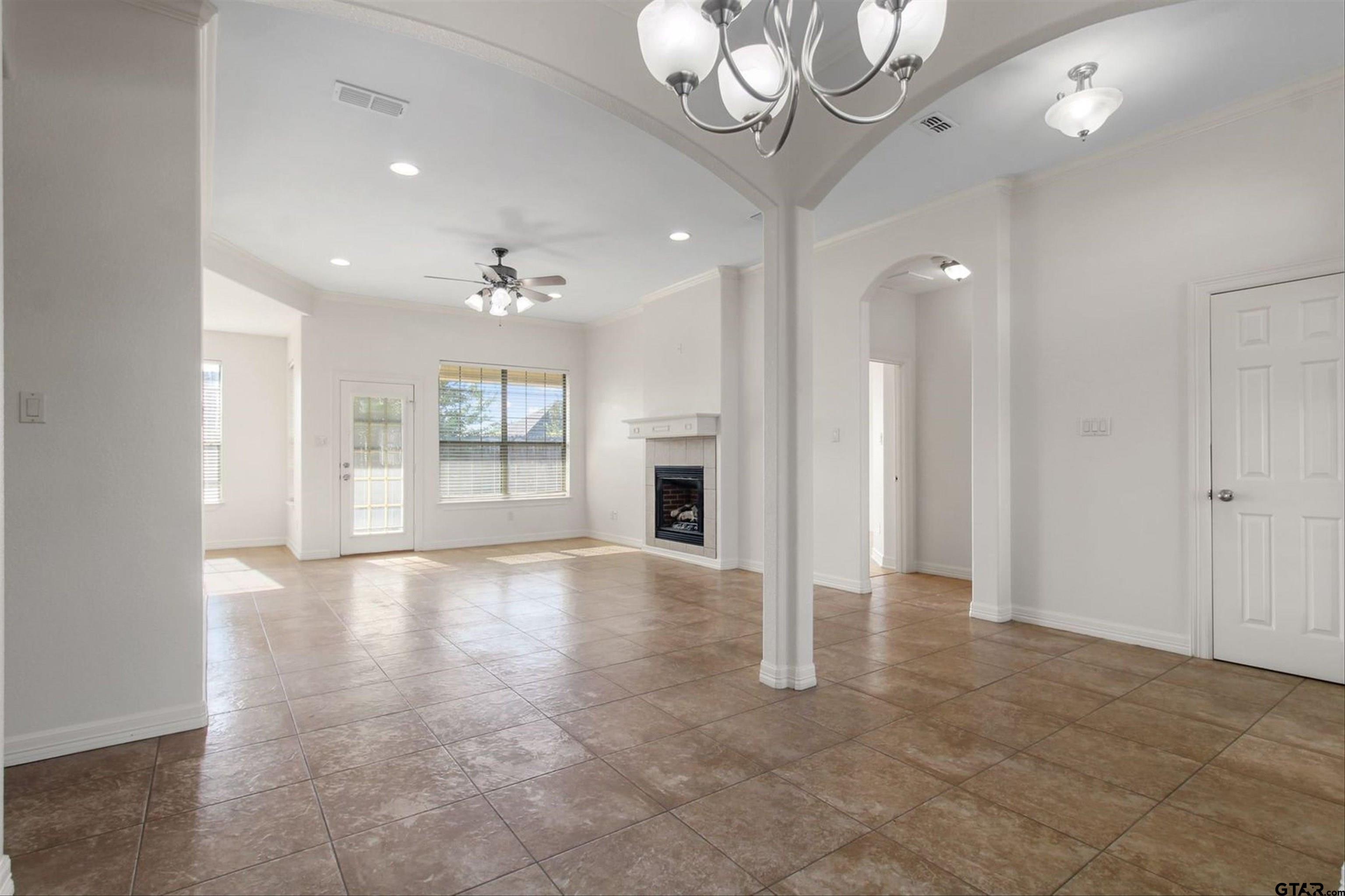 452 Princess Place Tyler, TX 75704 - Photo 1 of 20 a view of an empty room with a fireplace and a window