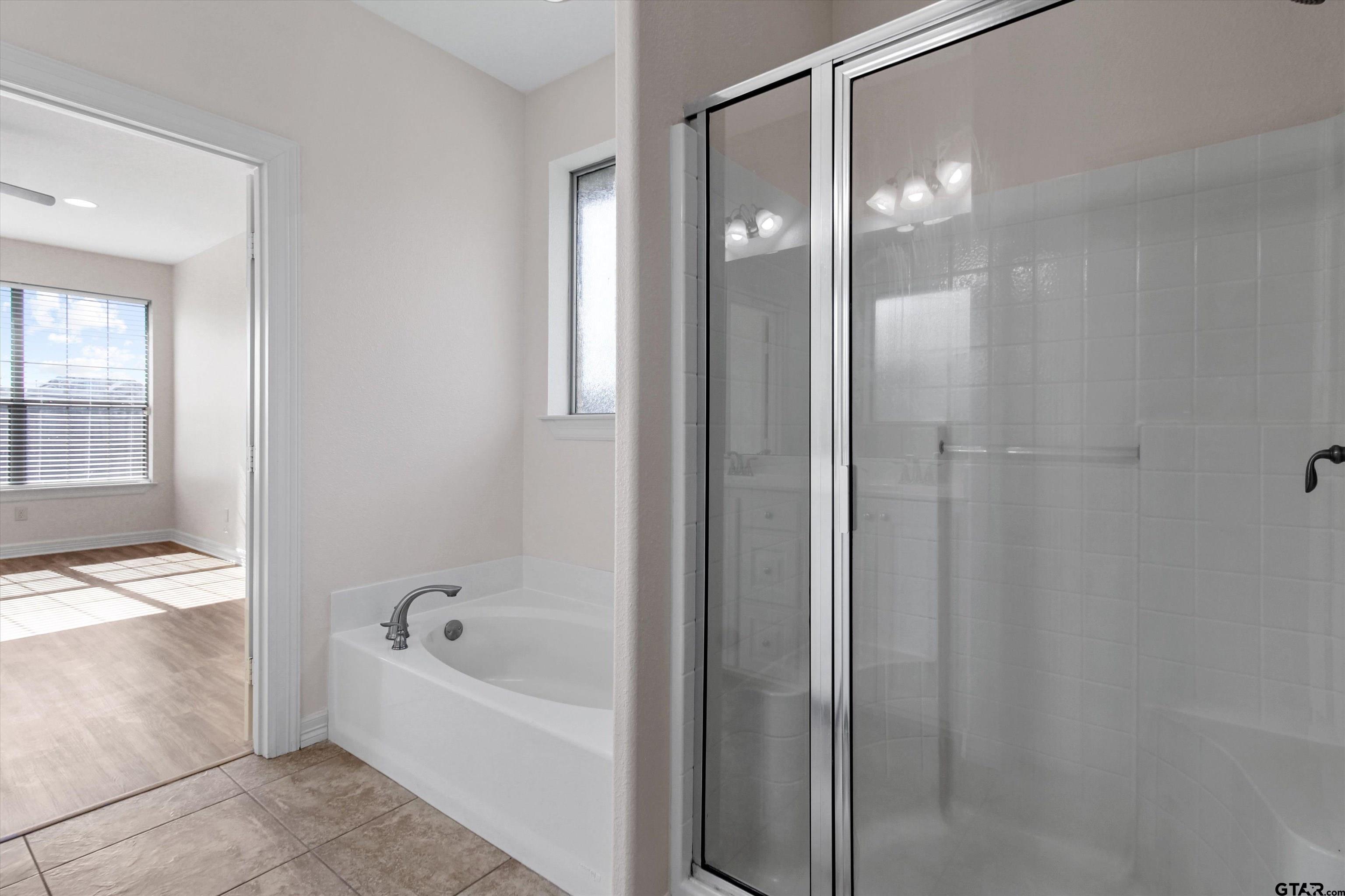 452 Princess Place Tyler, TX 75704 - Photo 11 of 20 a bathroom with a bathtub and a shower