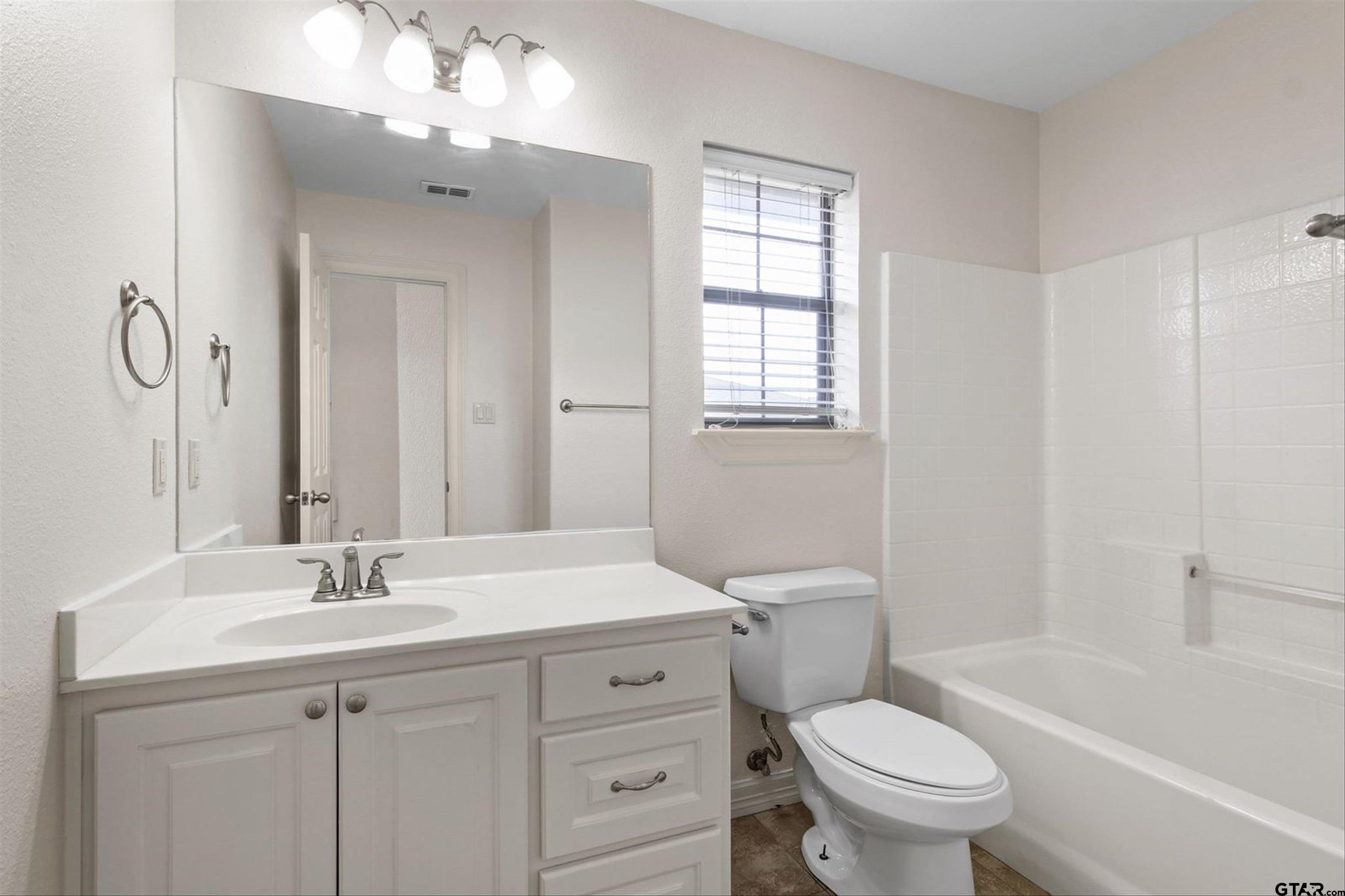 452 Princess Place Tyler, TX 75704 - Photo 16 of 20 a bathroom with a sink a toilet and shower