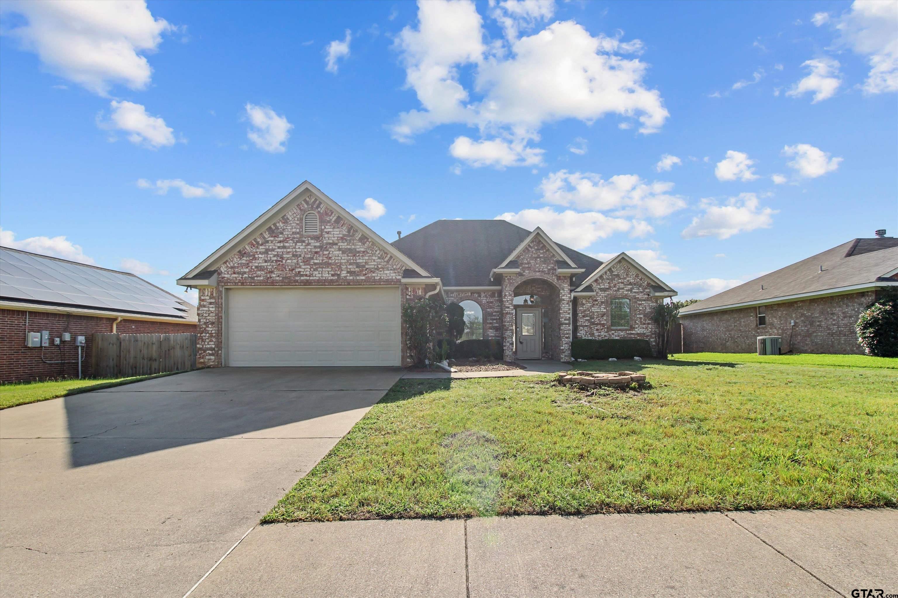 452 Princess Place Tyler, TX 75704 - Photo 2 of 20 a front view of a house with a yard and garage