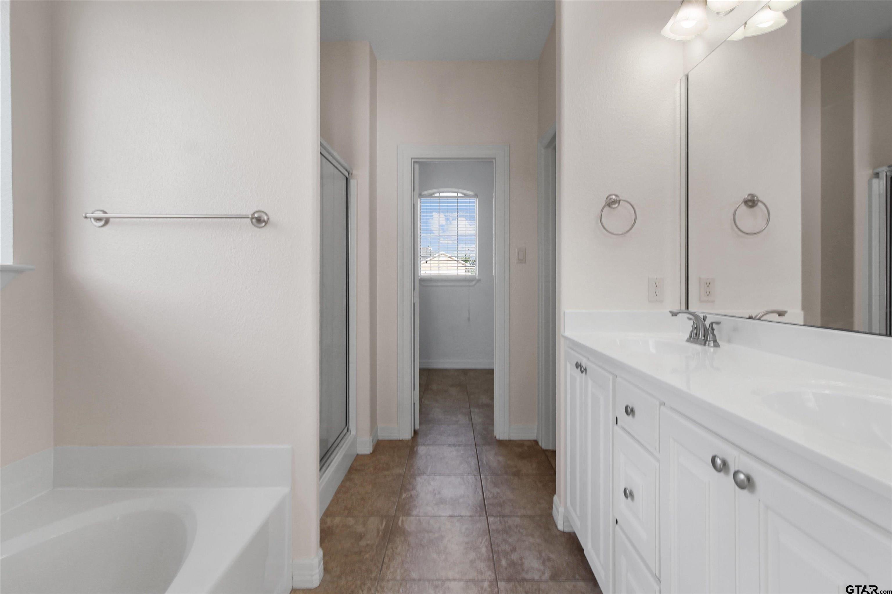 452 Princess Place Tyler, TX 75704 - Photo 10 of 20 a bathroom with a double vanity sink mirror and bathtub